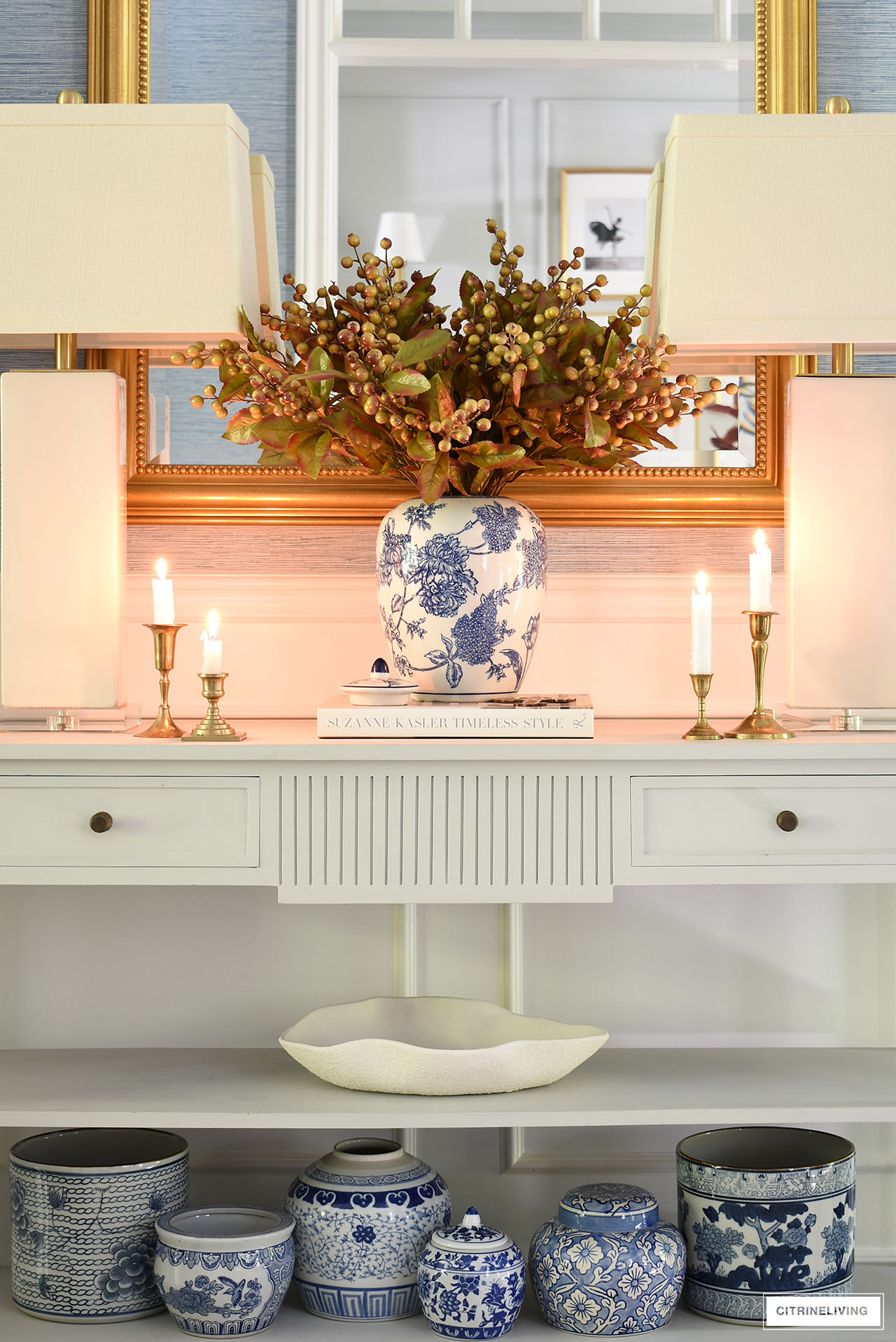 Blue and white pottery in varied sizes anchors a beautifully decorated fall console table.