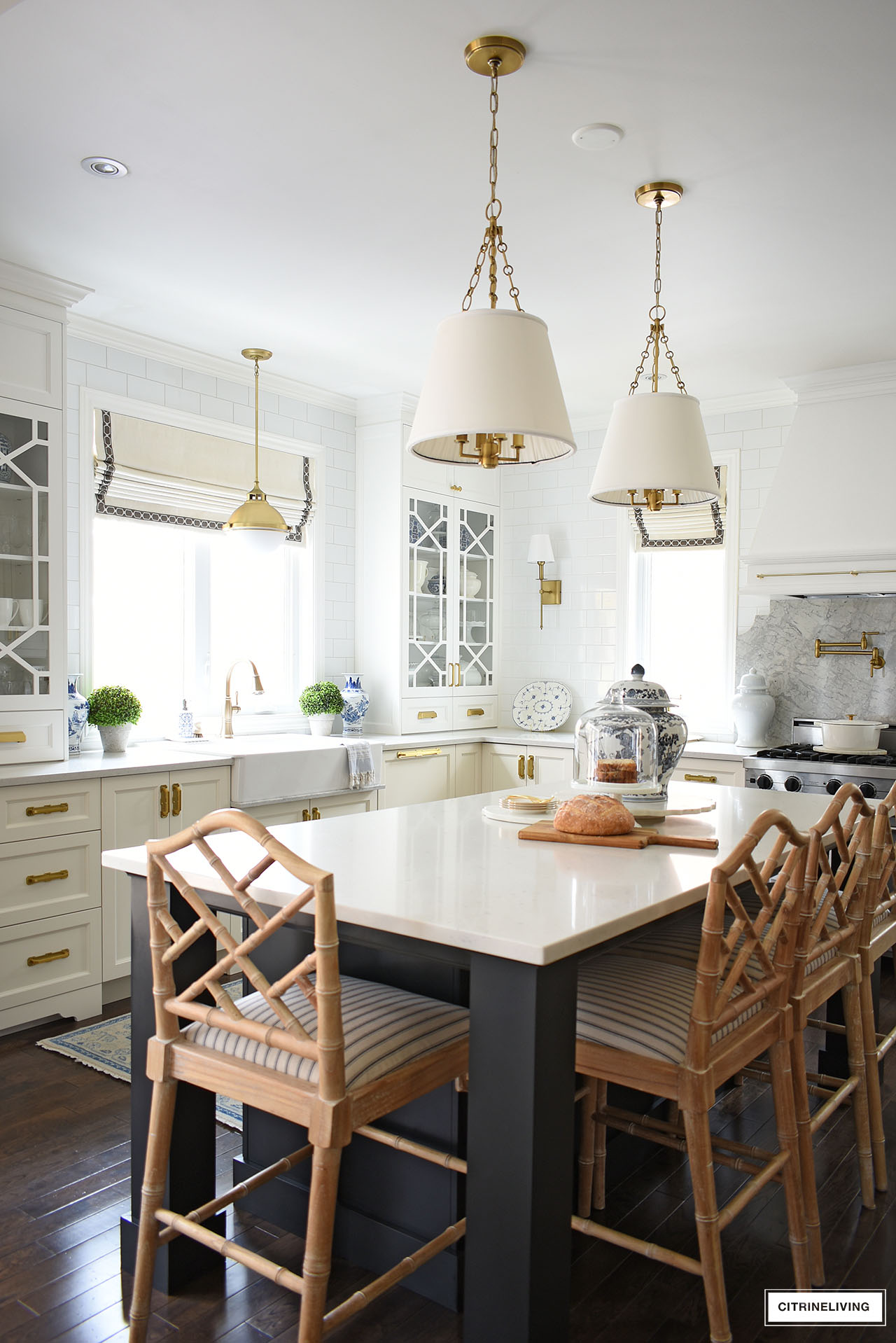 white kitchen with custom glass cabinet doors in a trellis/fretwork pattern and center island