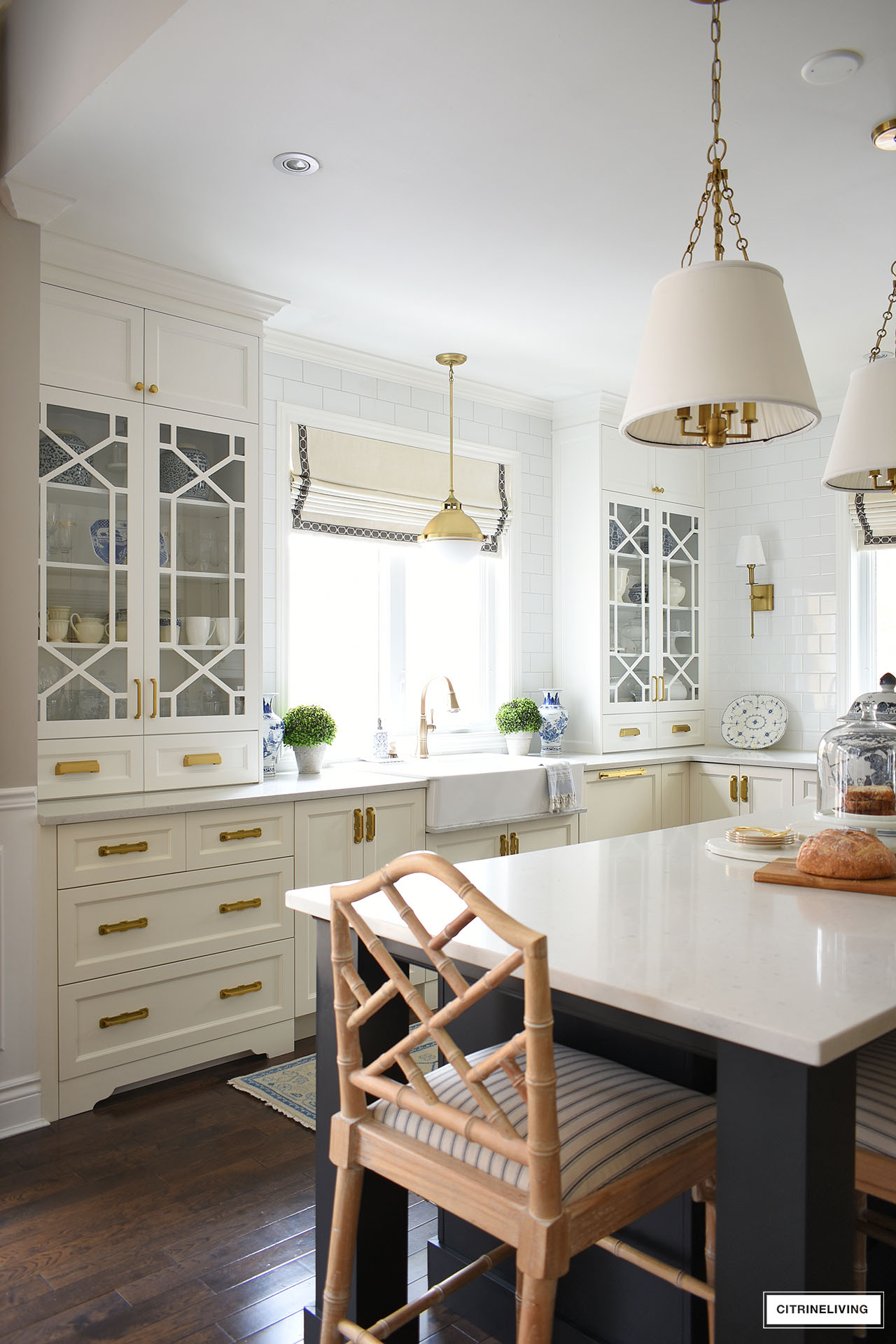 white kitchen with custom glass cabinet doors in a trellis/fretwork pattern