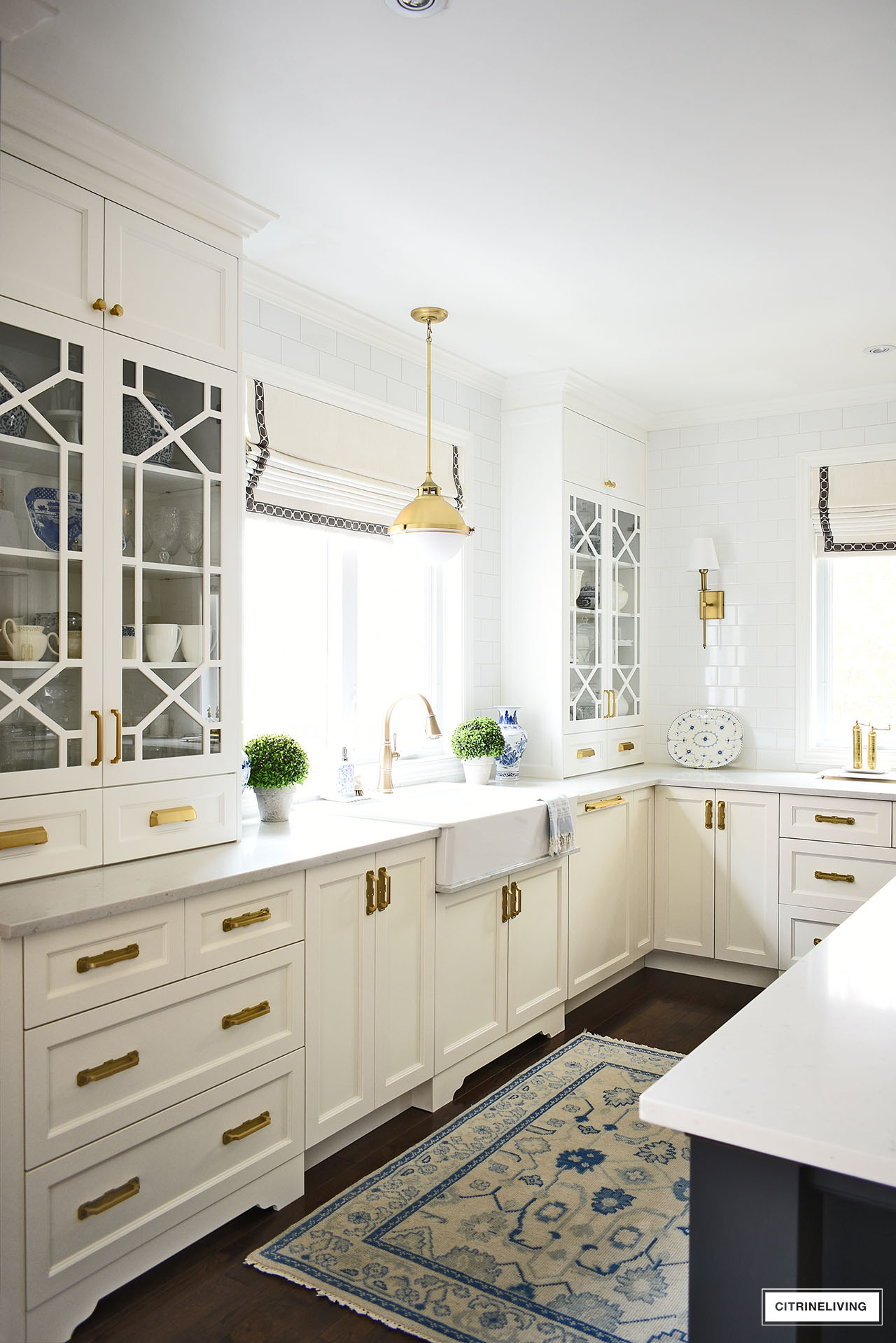 white kitchen with custom glass cabinet doors in a trellis/fretwork pattern