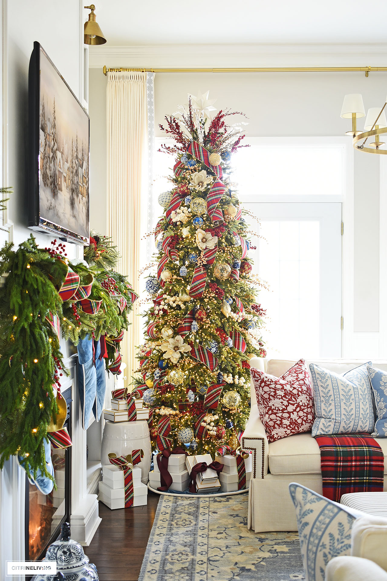 Christmas tree decorated with red plaid ribbon and blue and white ornaments