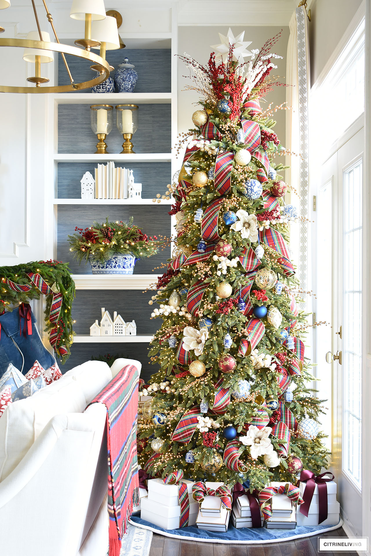 Christmas tree decorated with red plaid ribbon and blue and white ornaments