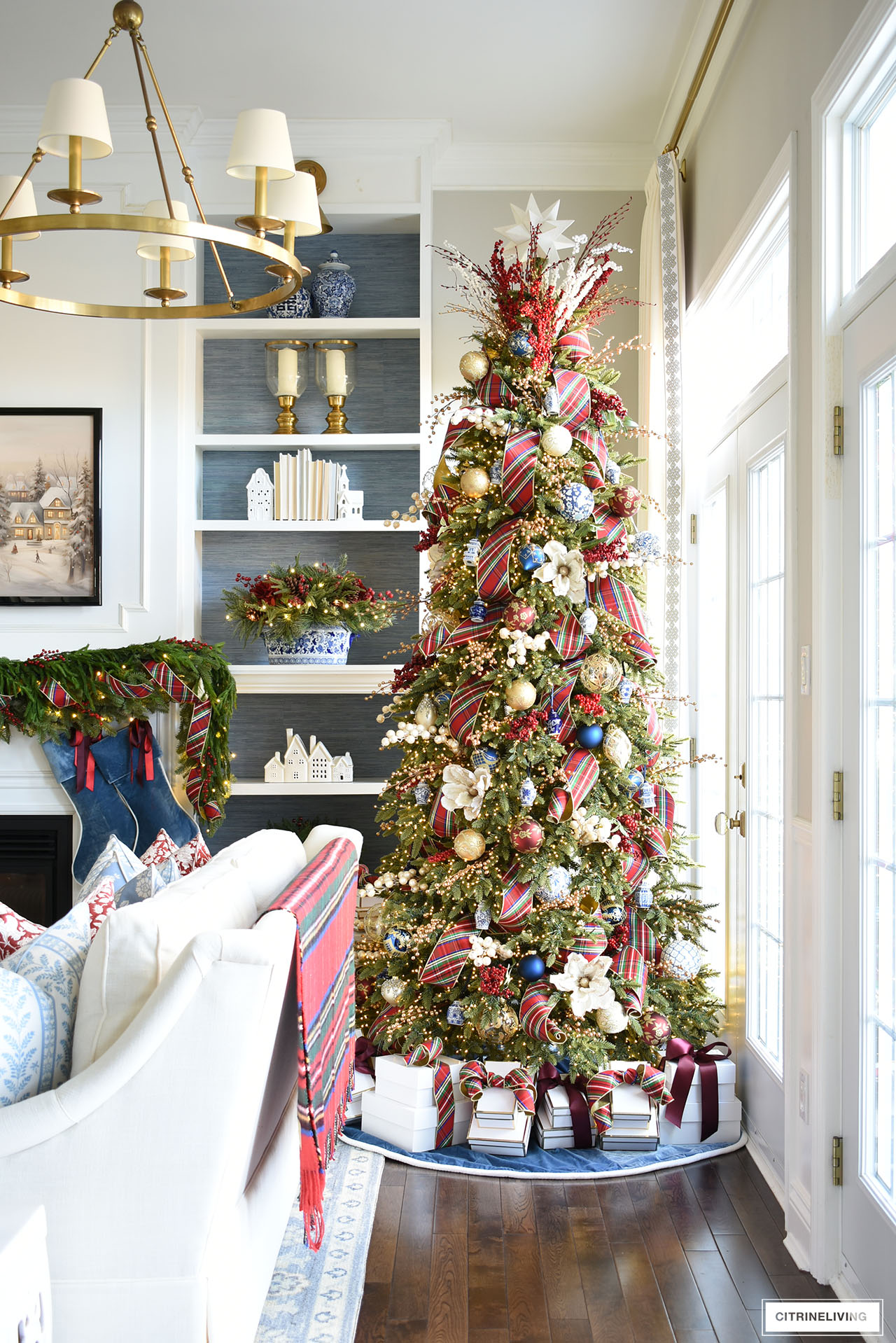 Christmas tree decorated with red plaid ribbon and blue and white ornaments