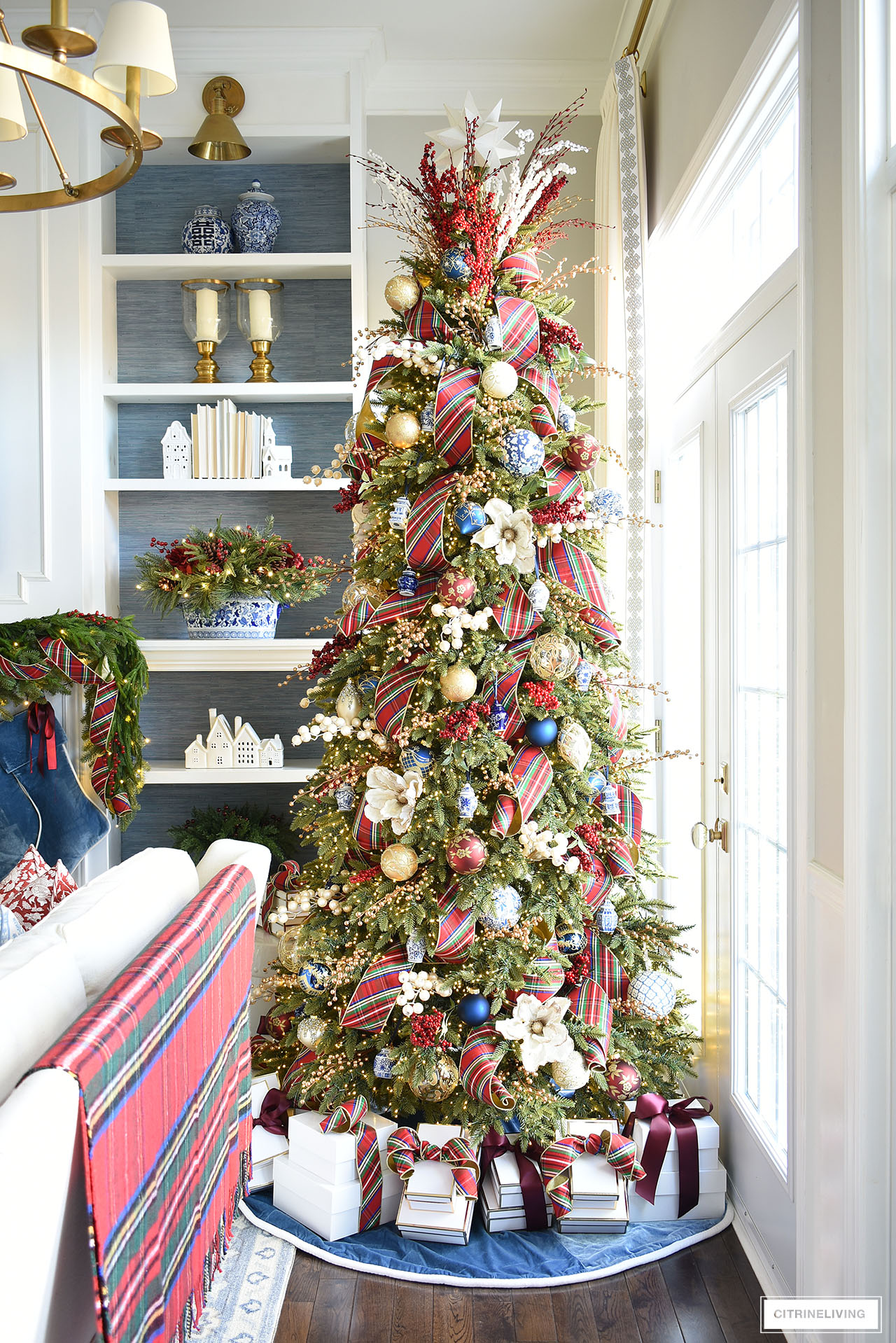 Christmas tree decorated with red plaid ribbon, blue and white chinoiserie ornamnets.