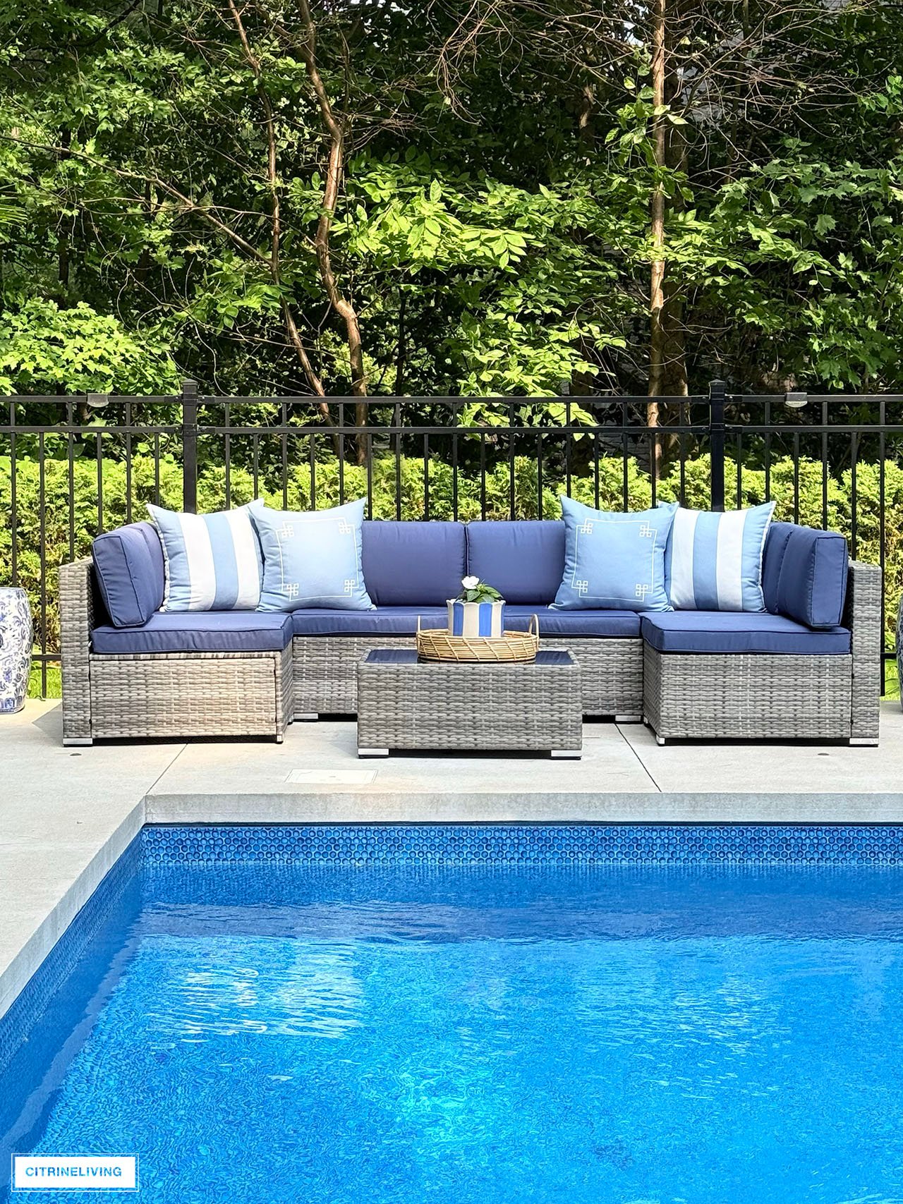 Outdoor modular sofa with striped and greek key cushions
