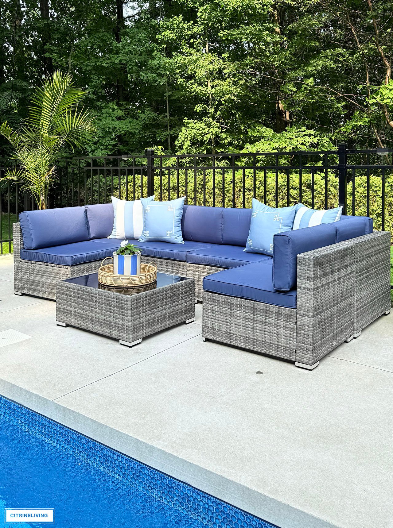 Outdoor modular sofa with striped and greek key cushions