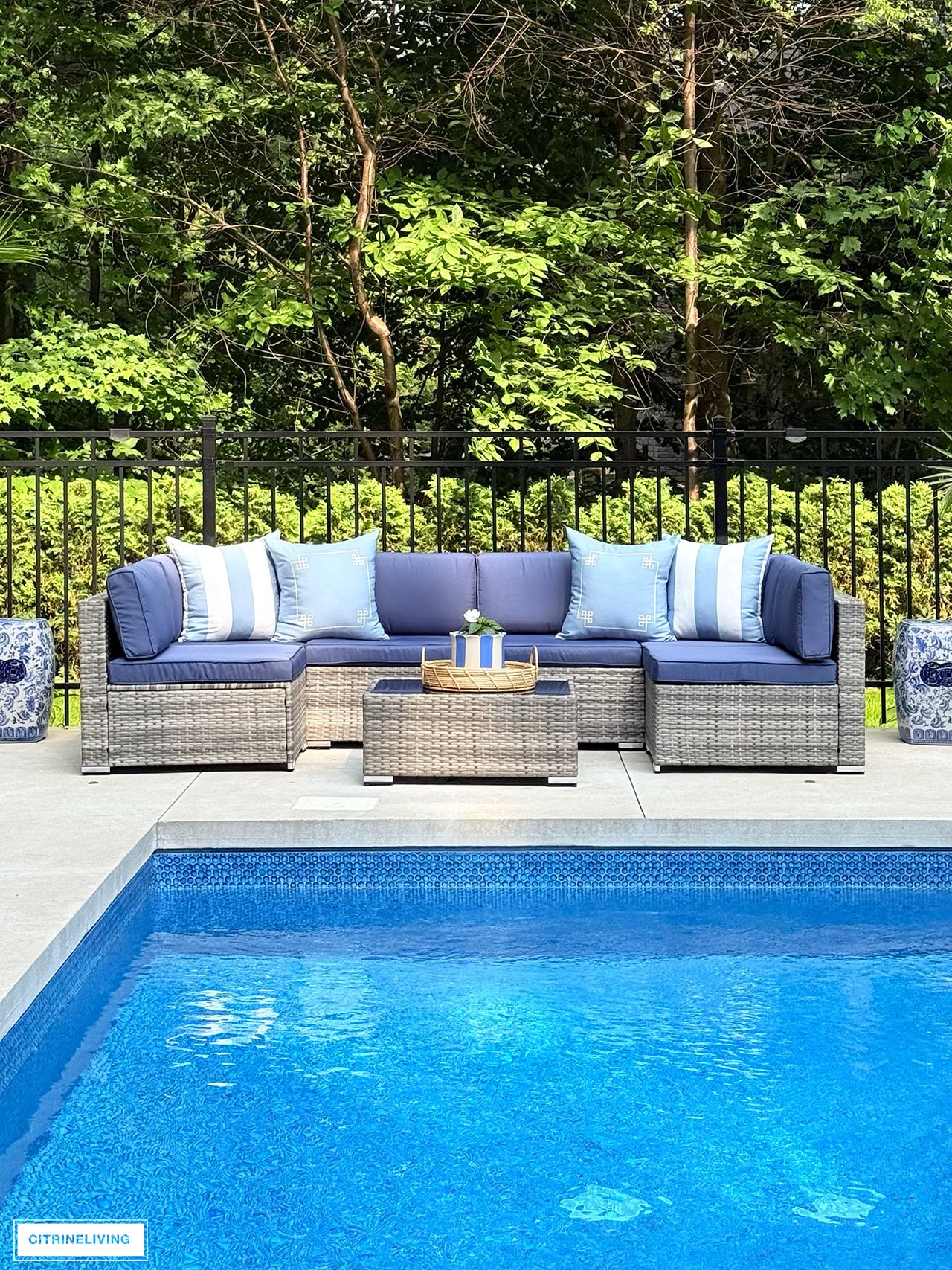 Outdoor modular sofa with striped and greek key cushions