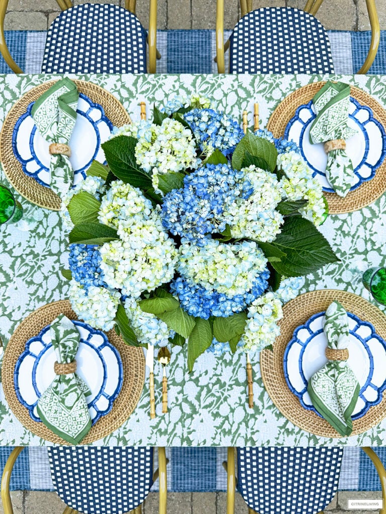 OUTDOOR SUMMER TABLESCAPE IN BLUE AND GREEN WITH LUSH HYDRANGEAS